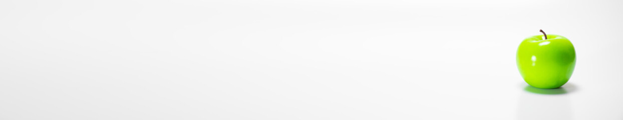 One single green apple with raindrops on a wooden background with a place for text banner: rustic food, harvest gardening, ingredients for a healthy snack, soft focus