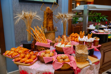 Easter cakes on the table against the background of the mill. Buffet table