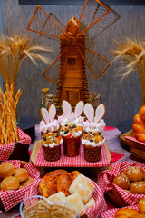 Easter cakes on the table against the background of the mill. Buffet table