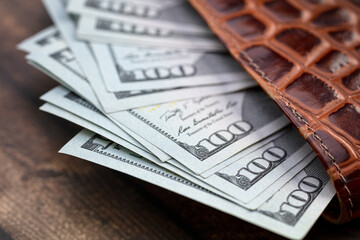 Lots of american hundred dollar bills in a leather wallet. Has a clipping path saved.