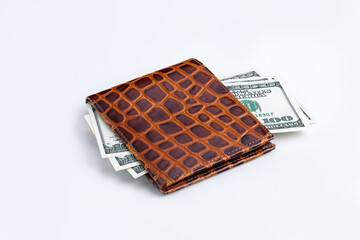 One hundred dollar american banknotes in a leather wallet isolated on a white background. Close-up. Has a clipping path saved.