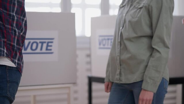 People Standing In Queue At Polling Station, Waiting For Registration To Vote