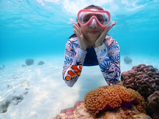 Tourist people diving with snorkel to see nemo fish , beautiful fish and coral at Samaesarn Island...