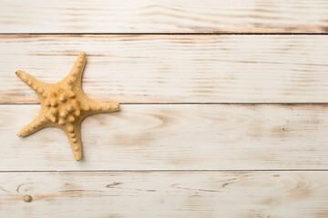 Fototapeta na wymiar Starfish on wooden background, top view