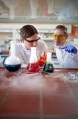 students in uniform making some experiment in lab