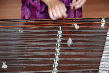 The cimbalom instrument played by a musician