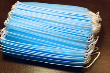 stack of corona virus face masks on a table