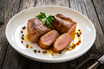 Roasted pork loin on wooden table
