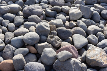 TEXTURE OF ROUND STONES ON THE BEACH