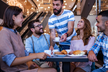 Group of friends meeting in the local coffee shop