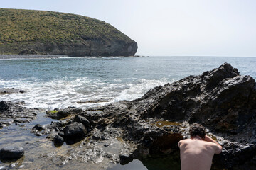 Fototapeta na wymiar MAN RELAXING ON A PARADISIACAL BEACH