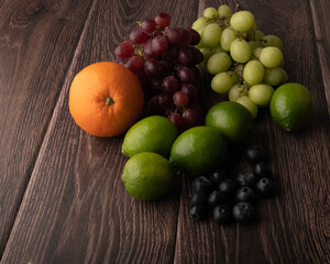 Naklejka na ściany i meble Mixed fruit on a wooden table background