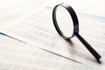 Fototapeta premium Single Magnifying Glass with Black Handle,staying on the financial data. Business and Finance concept,