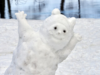 Funny snowman in the city park close-up