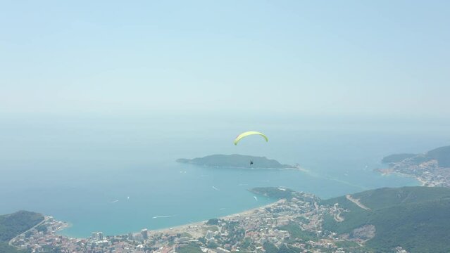 Paraglider flying above city of Budva, Montenegro