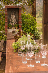 beautiful outdoor table setup with plants and Virgin Mary in the background in Mexico