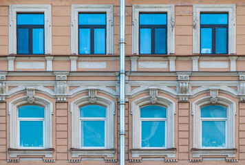 Several windows in a row on the facade of the urban historic apartment building front view, Saint Petersburg, Russia  © dr_verner