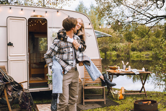 Young just married couple traveling in camper,house on wheels,trailer,motor home.Love romantic road travel,freedom life.Campsite overnight in van.Wanderlust vacation,weekend. Girl,guy,happy adventure