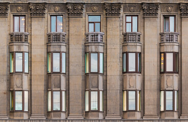 Many windows in a row on the facade of the urban historic apartment building front view, Saint Petersburg, Russia

