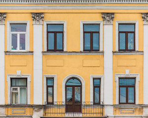 Balcony and several windows in a row on the facade of the urban historic apartment building front view, Saint Petersburg, Russia  © dr_verner