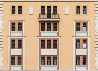Balcony and many windows in a row on the facade of the modern urban apartment building front view, Krasnaya Polyana, Sochi, Krasnodar Krai, Russia
