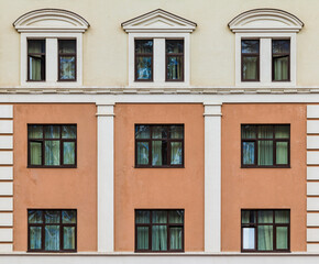 Fototapeta na wymiar Many windows in a row on the facade of the modern urban apartment building front view, Krasnaya Polyana, Sochi, Krasnodar Krai, Russia 