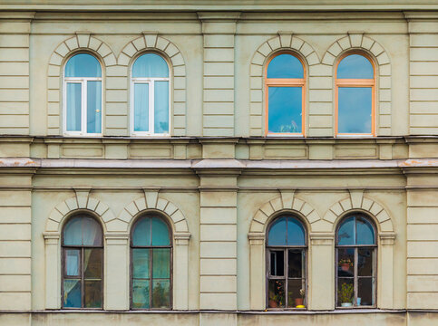 Several windows in a row on the facade of the urban historic apartment building front view, Saint Petersburg, Russia
