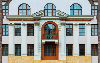 Balcony and many windows in a row on the facade of the modern urban apartment building front view,...