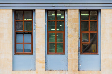 Three windows in a row on the facade of the modern urban apartment building front view, Krasnaya Polyana, Sochi, Krasnodar Krai, Russia
