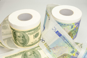 Rolls of bank notes toilet paper on white background