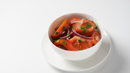 Tomato salad with red sweet onion, cut parsley and olive oil