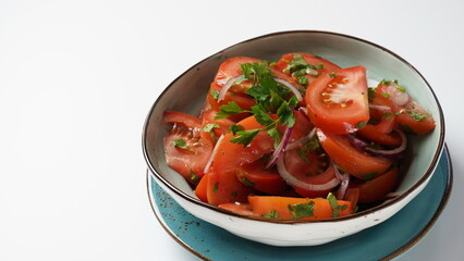 Tomato salad with red sweet onion, cut parsley and olive oil