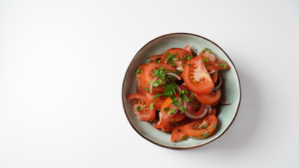 Tomato salad with red sweet onion, cut parsley and olive oil