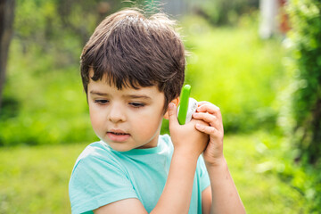 Small boy,kid,child play in walkie-talkie.Walkie Talkies with channels.Game of detectives,spies.Children talk,say messages at distance.Communication with parents. Forest,park,hike.Finding lost people