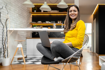 Portrait of beautiful woman using laptop at home