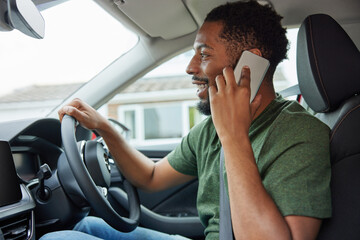 Fototapeta Man Talking On Mobile Phone Whilst Driving Car obraz