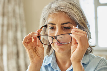 Smiling Mature Woman Trying On New Glasses At Home