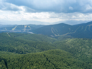 Fototapeta na wymiar Green mountains of Ukrainian Carpathians in summer. Sunny day, rare clouds. Aerial drone view.