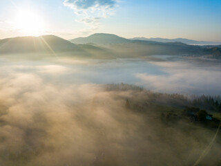 Green mountains of the Ukrainian Carpathians in the morning mist. Aerial drone view.