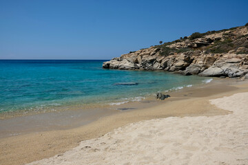 Fototapeta na wymiar The paradisiac beach with turquoise waters and golden sand of Pikri Nero in Ios Greece