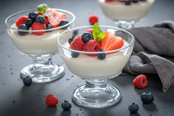 Sweet and fresh Panna Cotta with raspberries and blueberries.