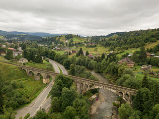 Old railway bridge in the mountains. Ukrainian Carpathians. Aerial drone view.