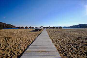 A wooden path leading to the famous sandy beach of Mylopotas in Ios