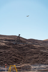 Vertical view from the viewpoint of the San Jose Mine with bird flying, Chile