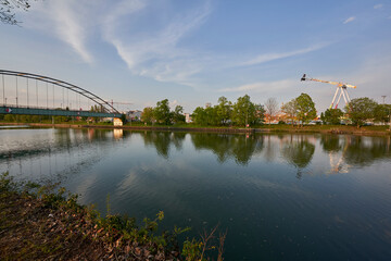 Spring festival (Frühlingsfest) with Fun rides and carousels by the river at evening. Germany,...