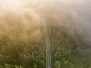 Mountain road in the fog. Aerial drone view.