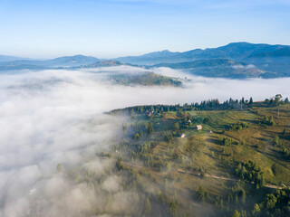 Morning fog in the Ukrainian Carpathians. Aerial drone view.