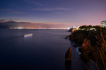 Fototapeta na wymiar Beautiful night landscape with city on the seashore. Antalya, Turkey.