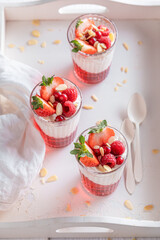 Homemade and tasty red jelly served with berries in glass.