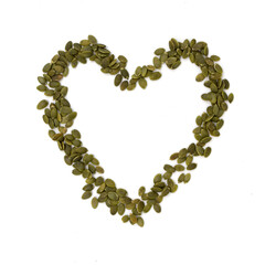 heart of green pumpkin seeds isolated on white background